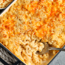 serving baked mac and cheese with a spoon