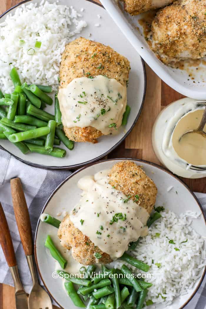 Overhead shot of two plates of Chicken Cordon Bleu served with rice and green beans