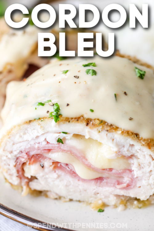 close up of cooked Chicken Cordon Bleu on a plate with a title