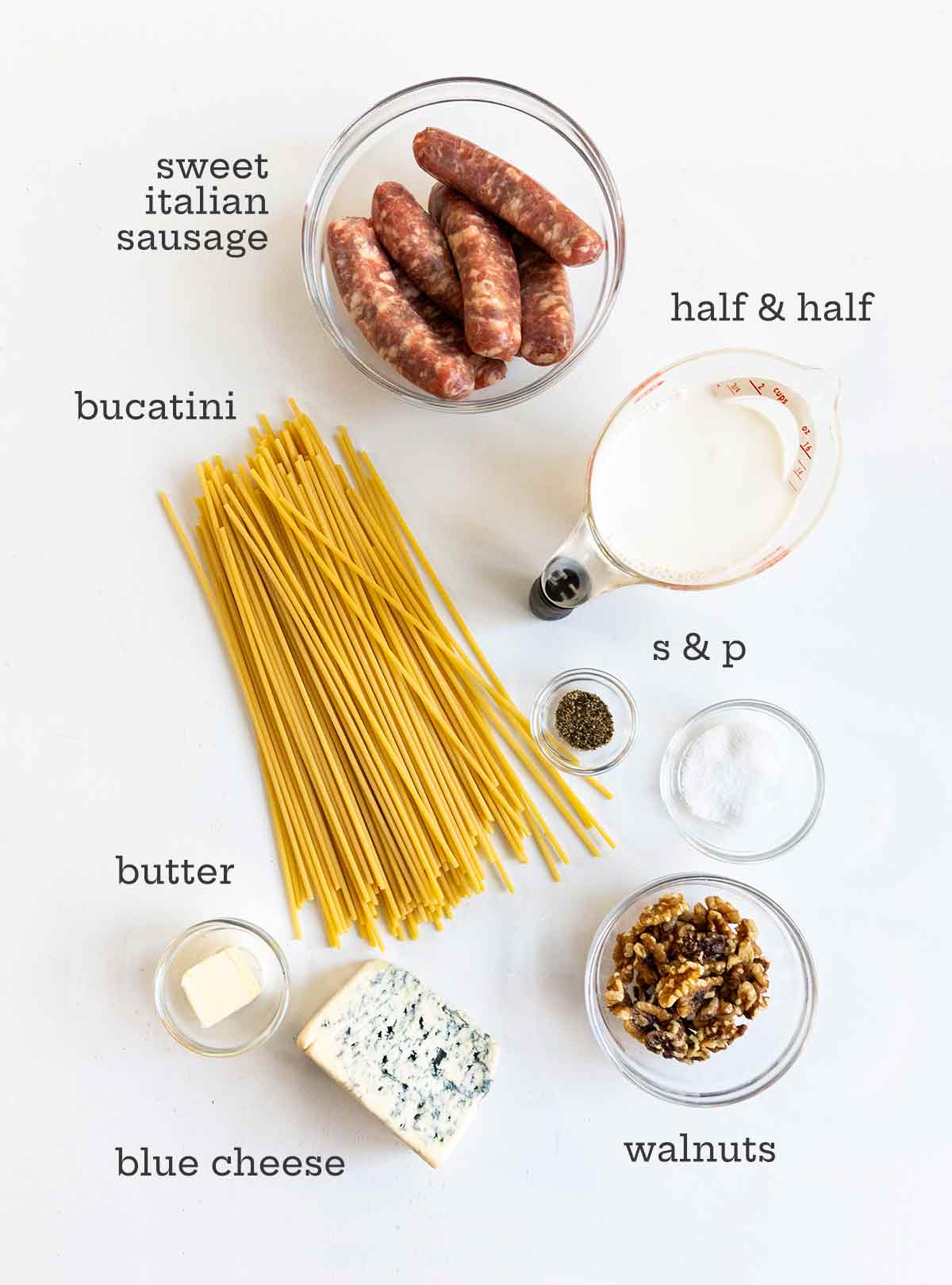 Blue cheese pasta ingredients: pasta, cheese, walnuts, half and half, sausage, and butter.
